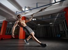 Fitness man workout on the rings HIIT workouts.